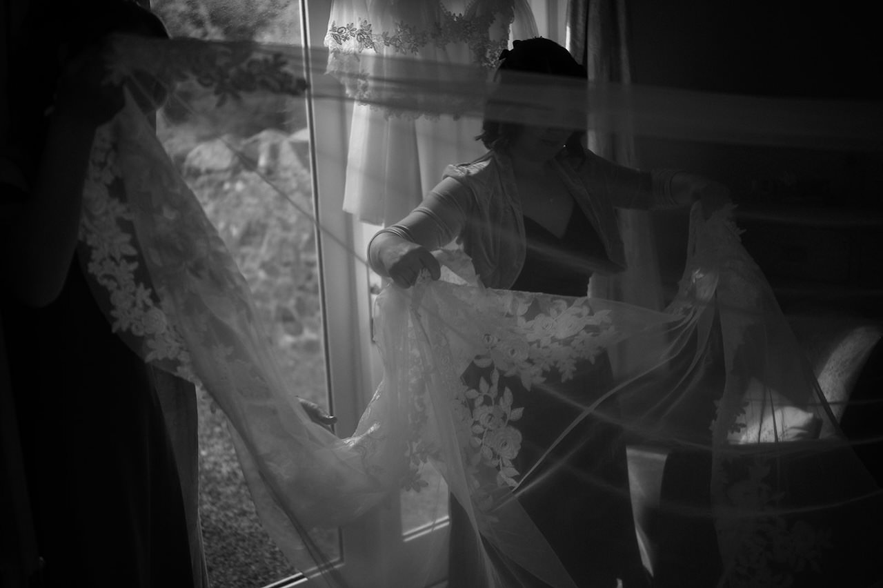 Bridesmaids preparing wedding veils indoors