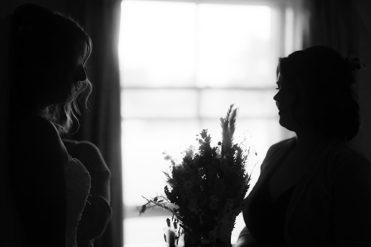 Bridesmaid with bouquet, soft lighting.