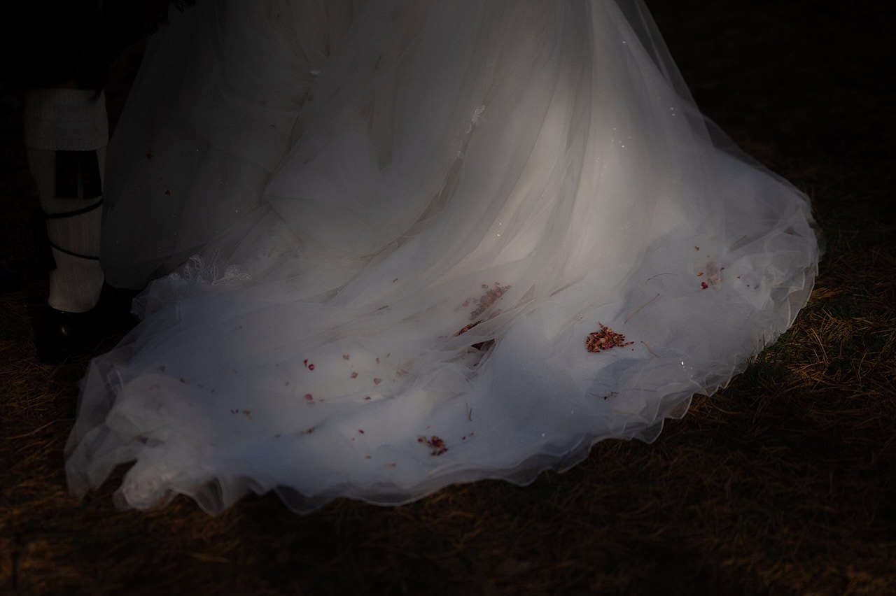 Dry petal confetti on bride's wedding dress