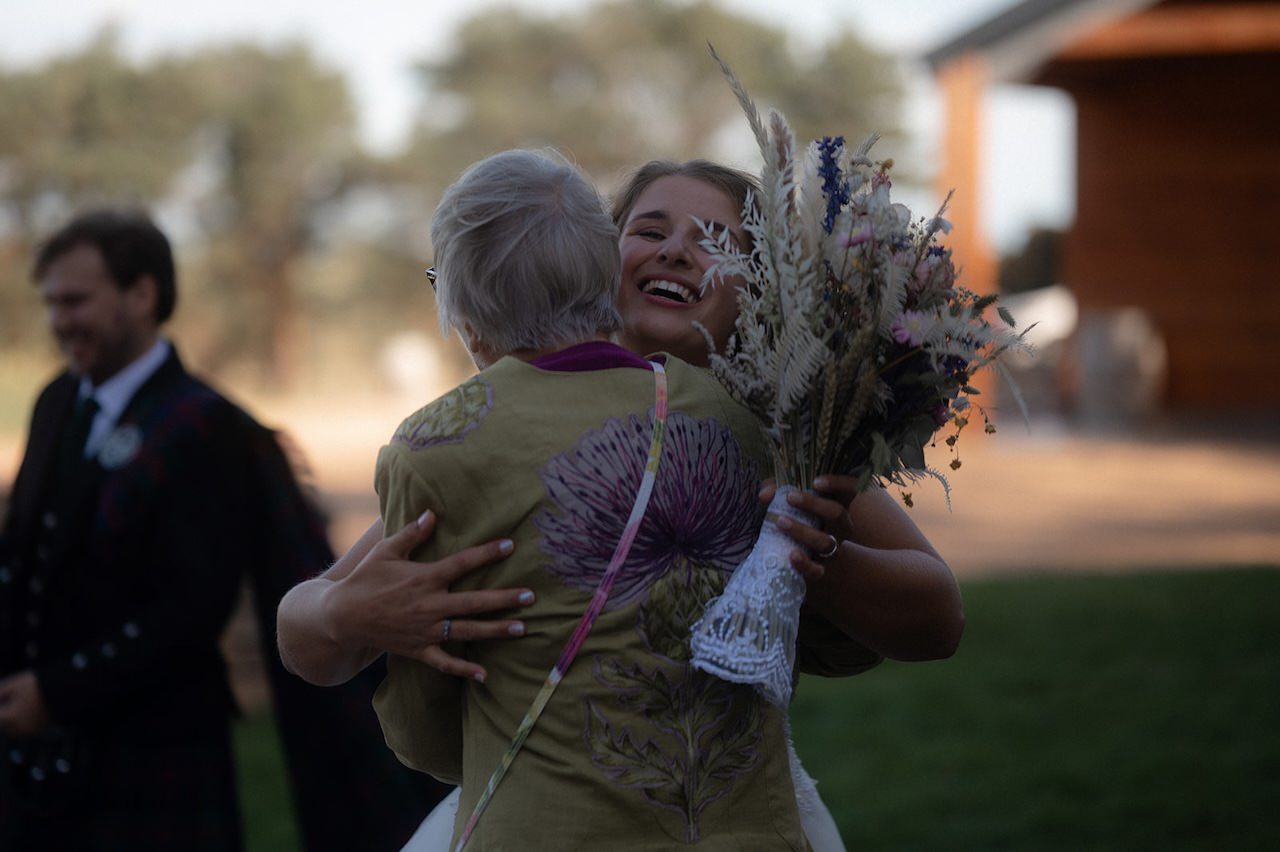 Wedding day Bride hug guest