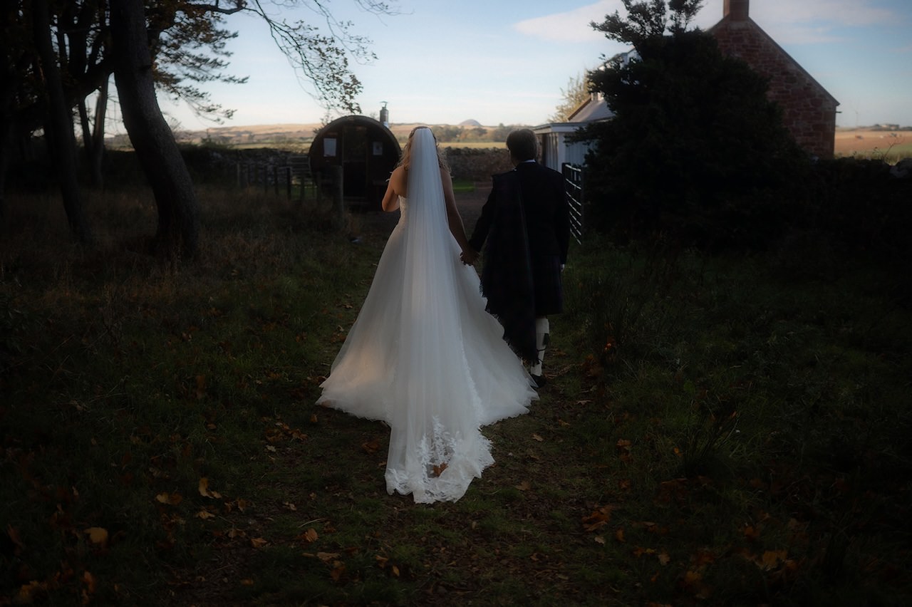 Scottish Wedding bride and groom walking to the barn venue