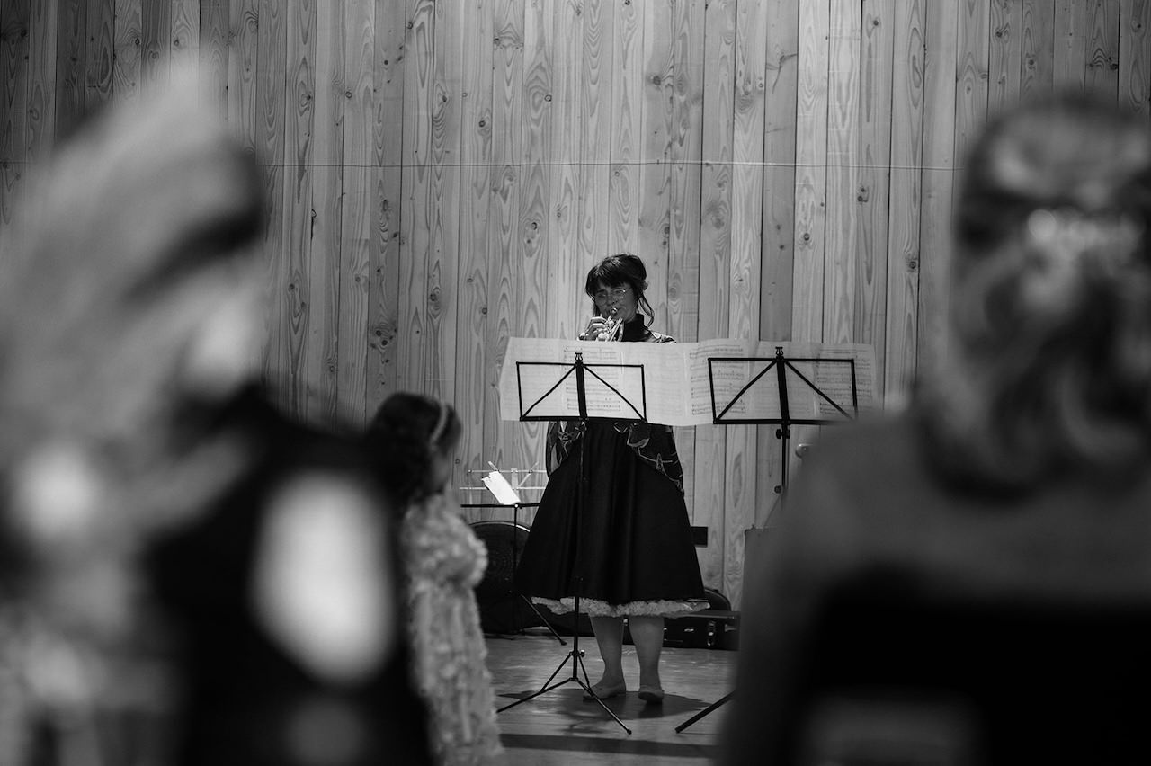 Wedding reception Bride's mum play trumpet in from of the wedding guests